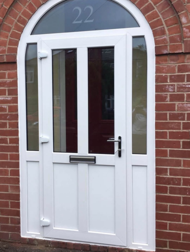 White uPVC arched door with red glazing