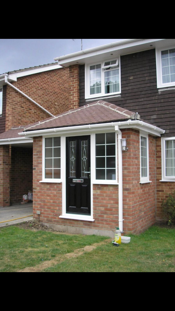 Classic brick porch with black composite door and grid sidelights
